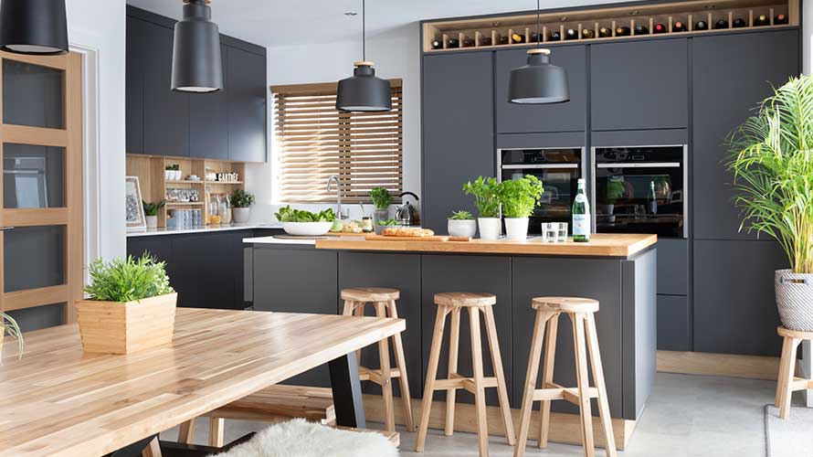 Modern dark kitchen featuring warming wood