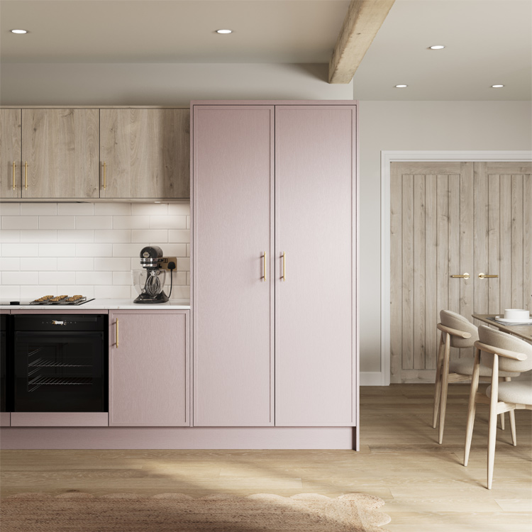 A pale pink kitchen larder unit with pink Shaker kitchen doors