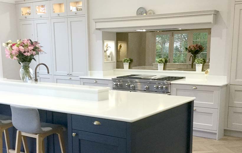 Blue kitchen island featuring grey kitchen cabinetry