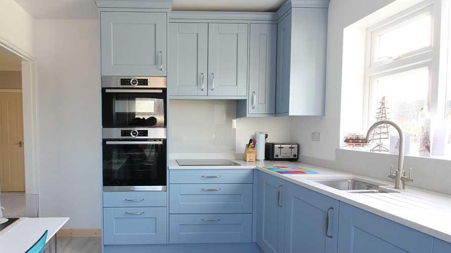 Small Shaker kitchen with light blue cabinet doors and D handles
