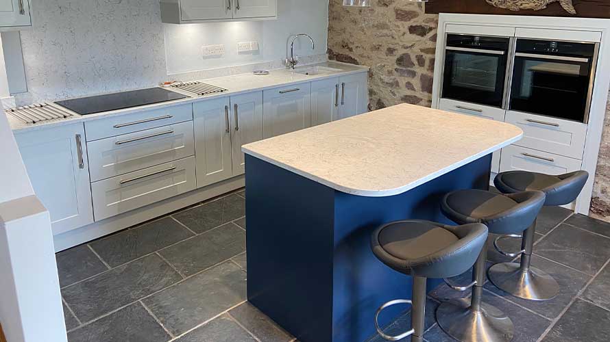 Small kitchen island in a dark blue shaker kitchen