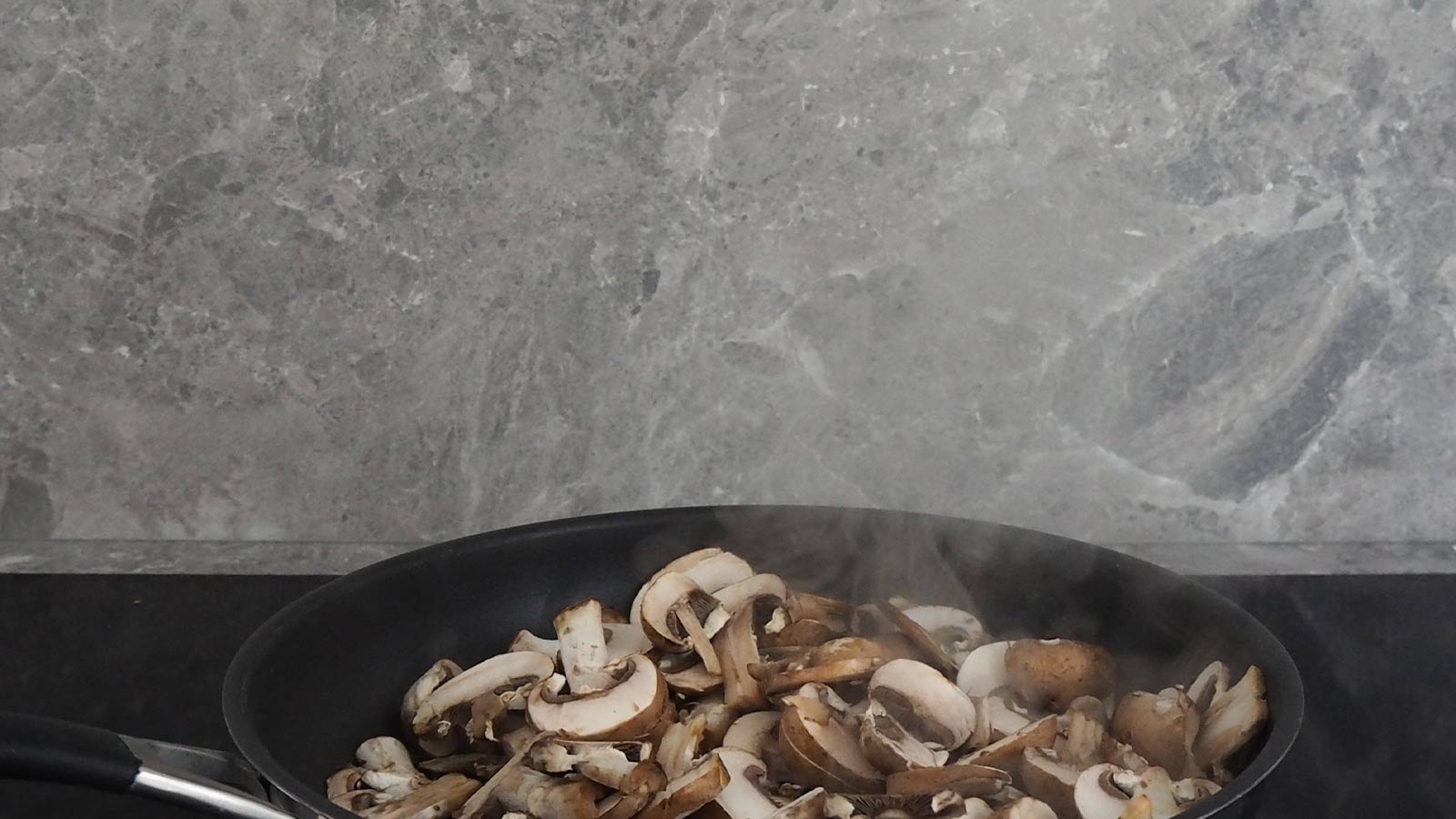 Stone effect splashback in a modern kitchen